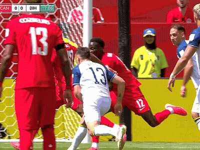 A Soccer Player With The Number 13 On His Jersey Is Being Tackled By Another Player GIF