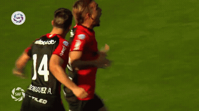 A Soccer Player With The Number 14 On His Back Is Hugging Another Player GIF