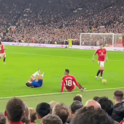 A Soccer Player With The Number 18 On His Jersey Is Sitting On The Ground GIF