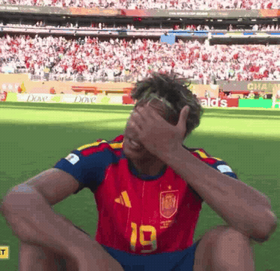A Soccer Player With The Number 19 On His Jersey Covering His Face GIF