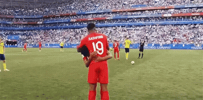 A Soccer Player With The Number 19 On His Jersey Is Hugging Another Soccer Player . GIF