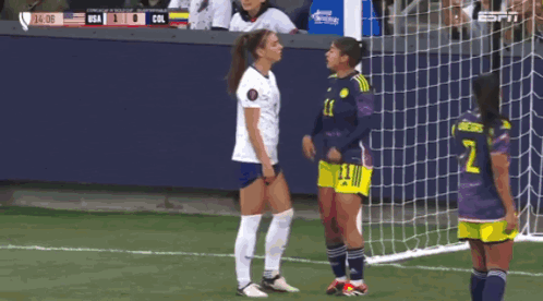 A Soccer Player With The Number 2 On Her Shorts Stands Next To Another Player GIF