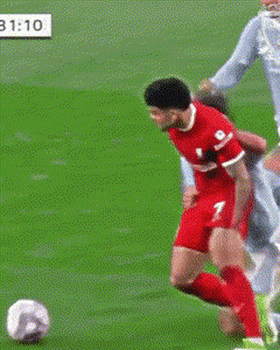 A Soccer Player With The Number 2 On His Shorts Is Trying To Tackle Another Player GIF