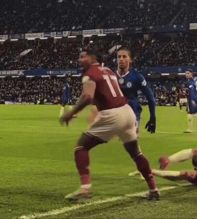 A Soccer Player With The Number 20 On His Shorts Is Being Tackled By Another Player GIF