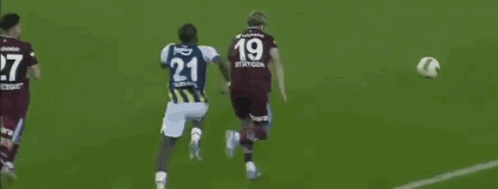 A Soccer Player With The Number 21 On His Jersey Kicks The Ball GIF
