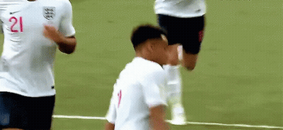 A Soccer Player With The Number 21 On His Shirt Is Standing On A Field . GIF
