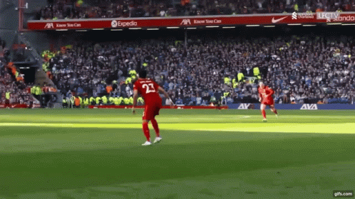A Soccer Player With The Number 23 On His Jersey Is Kicking The Ball GIF