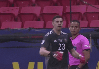 A Soccer Player With The Number 23 On His Jersey Is Standing In Front Of A Microphone . GIF