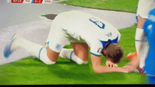 A Soccer Player With The Number 23 On His Jersey Kneeling On The Field GIF