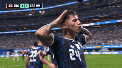 a soccer player with the number 24 on his jersey stands on the field
