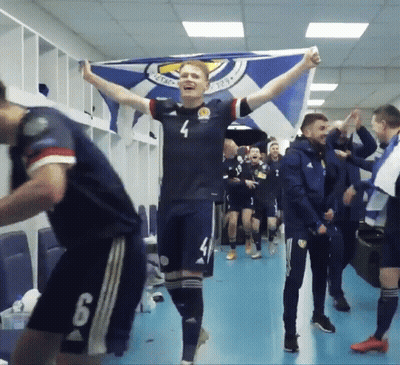 A Soccer Player With The Number 4 On His Jersey Is Holding A Flag GIF
