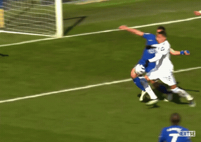 A Soccer Player With The Number 4 On His Jersey Is Surrounded By Other Players GIF