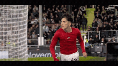 A Soccer Player With The Number 49 On His Shorts Is Celebrating A Goal GIF