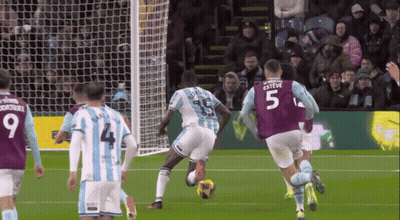 A Soccer Player With The Number 5 On His Jersey Kicks The Ball GIF