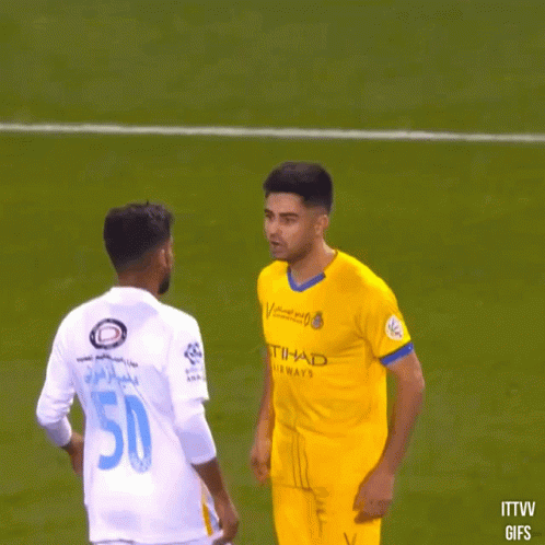 A Soccer Player With The Number 50 On His Back Talks To Another Player GIF