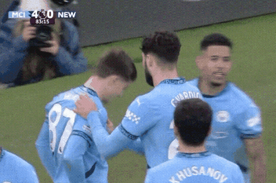 A Soccer Player With The Number 87 On His Jersey Hugs Another Player GIF