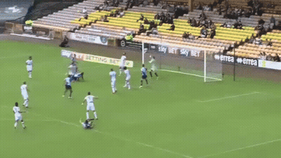 A Soccer Player With The Number 9 On His Jersey Is Laying On The Ground Surrounded By Other Players . GIF
