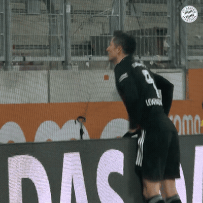 A Soccer Player With The Number 9 On His Jersey Leans Over A Wall GIF