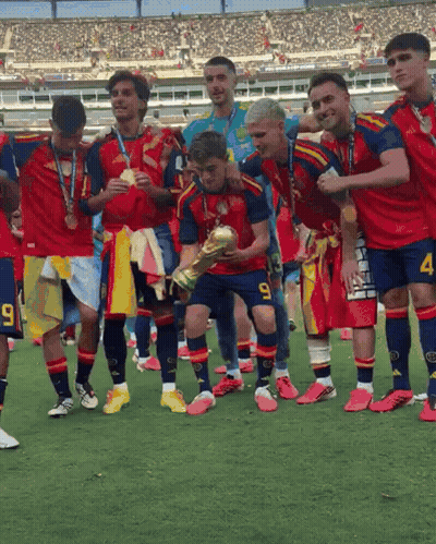 A Soccer Player With The Number 9 On His Shorts Is Holding A Trophy With His Teammates GIF