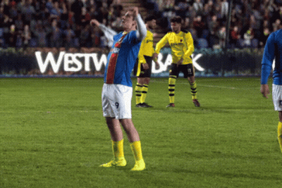 A Soccer Player With The Number 9 On His Shorts Stands On A Field GIF
