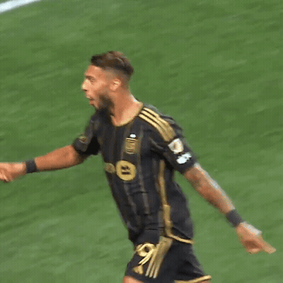 A Soccer Player With The Number 99 On His Jersey Is Squatting On The Field GIF
