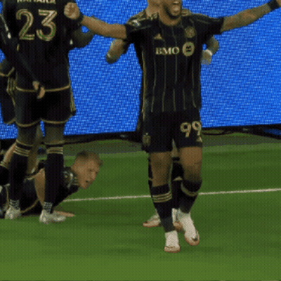 A Soccer Player With The Number 99 On His Shorts Celebrates A Goal GIF