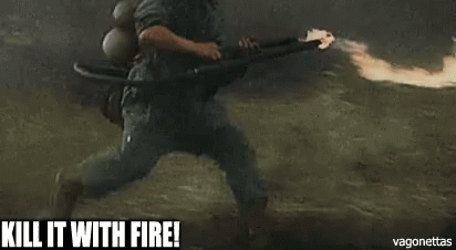 A Soldier Is Holding A Flamethrower In A Field And Says `` Kill It With Fire ! '' GIF