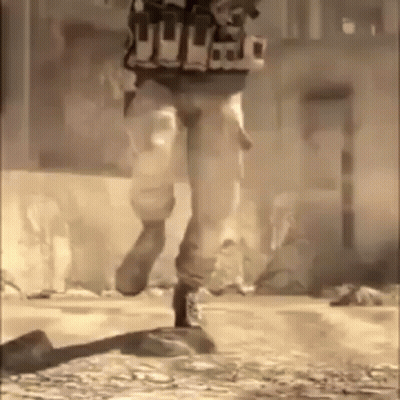 A Soldier Is Running Down A Street In A Video Game While Wearing A Vest . GIF