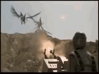 A Soldier Is Standing In Front Of A Machine Gun While A Dragon Is Flying In The Background . GIF