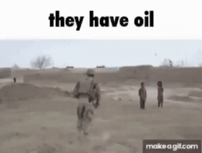 A Soldier Is Walking Through A Dirt Field With Two Children And Says They Have Oil . GIF