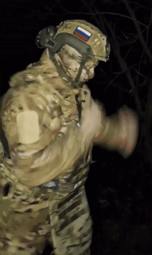 A Soldier Wearing A Helmet With A Russian Flag On It GIF
