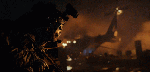 A Soldier With A Skull On His Helmet Holds A Rifle GIF