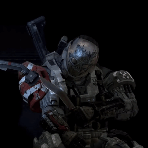 A Soldier With A Skull On His Helmet Is Holding A Gun GIF
