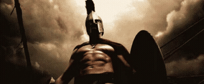 A Spartan Warrior Is Holding A Shield And Wearing A Helmet GIF