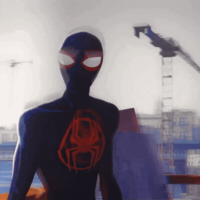A Spider Man Standing In Front Of A Building GIF