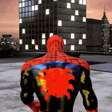 A Spider Man With A Red Spider On His Back Stands In Front Of A Building GIF
