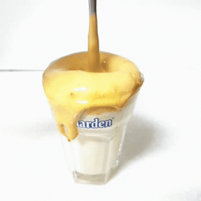 A Spoon Is Being Poured Into A Glass That Says Arden GIF