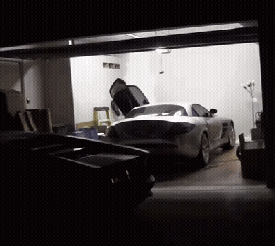A Sports Car Is Parked In A Garage With Its Hood Up GIF