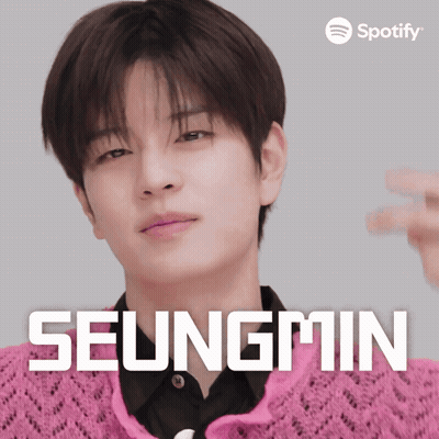 A Spotify Ad For Seungmin Shows A Man Wearing A Pink Sweater GIF