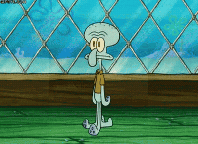A Squidward From Spongebob Squarepants Is Standing In Front Of A Chain Link Fence . GIF