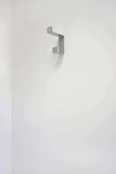 A Stack Of Black Pans Hanging On A Wall GIF