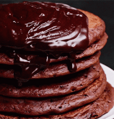 A Stack Of Chocolate Pancakes Covered In Chocolate Sauce GIF