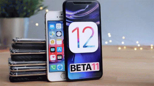 A Stack Of Iphones Sitting Next To A Beta 11 Iphone GIF