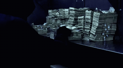 a stack of money on a table with a blue ribbon that says ' united states of america ' on it