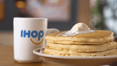 A Stack Of Pancakes Next To An Ihop Mug GIF