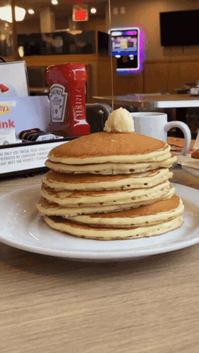 A Stack Of Pancakes On A Plate With A Bottle Of Heinz Ketchup Behind Them GIF