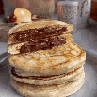 A Stack Of Pancakes With A Chocolate Filling GIF