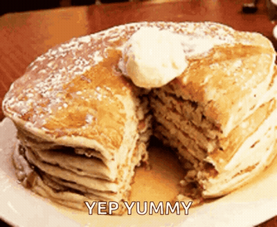 A Stack Of Pancakes With A Slice Taken Out Of One Of Them And The Words Yep Yummy Below It GIF