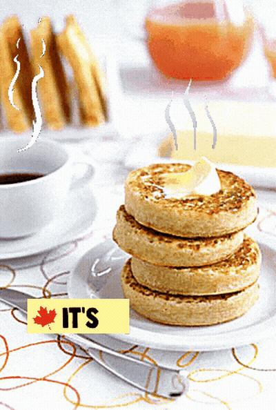 A Stack Of Pancakes With A Yellow Sign That Says It 'S On It GIF