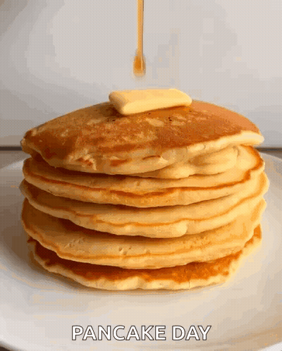 A Stack Of Pancakes With Butter And Syrup Being Poured On Them .. GIF